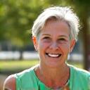 Smiling woman, early 40s, looking energetic and vibrant.